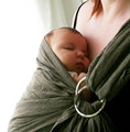 Keep the infant's head above the sling and away from the caregiver's body