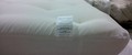Promo mattress with off-white casing showing mattress tag