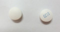 This is an image of two small white round pills of Olanzapine 10 milligram tablets 100. On the right, the pill has OZ10 in blue ink written on it. The pill on the left is blank.