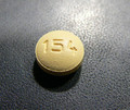 This is an image of two small round yellow pills of Ondansetron 8 milligram tablets. The pill has the number 154 encrusted on it.