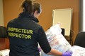 A Health Canada official inspects seized suspect counterfeit and illicit health products during Operation Pangea X, which took place worldwide from September 12-19, 2017.