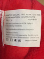 Label sewn in bathrobe showing item number 2013NW081 and “KREATIVE KIDS, INC.